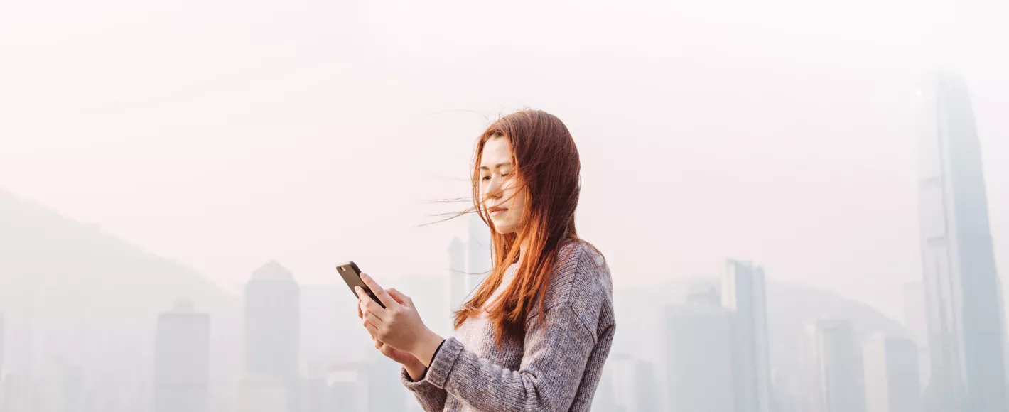 woman looking at mobile phone